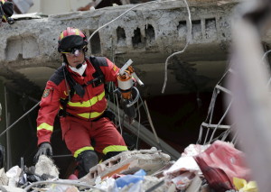 A rescue team member from Spain searches for victims at a collapsed building at the village of Manta, after an earthquake struck off Ecuador's Pacific coast, April 21, 2016. REUTERS/Henry Romero