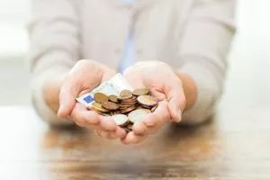 close up of senior woman hands holding money